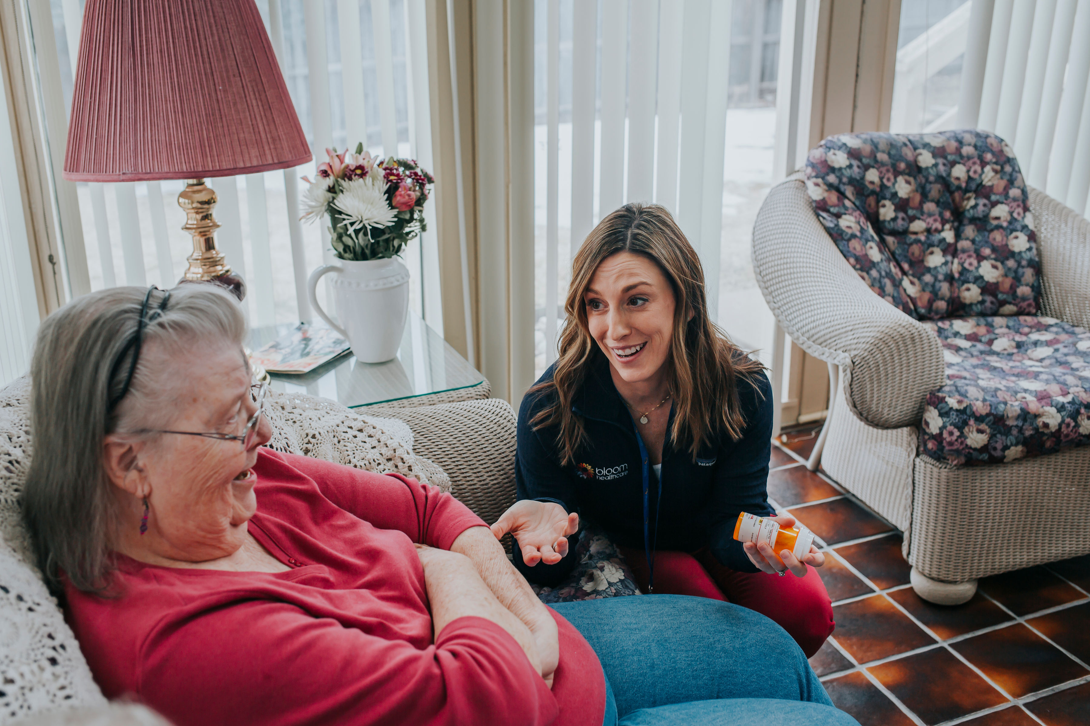 An image of a Bloom Healthcare caregiver discussing options with a smiling patient